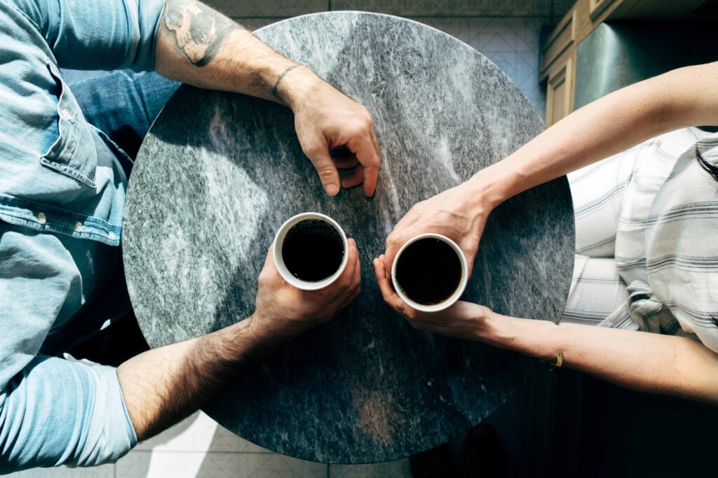 man and woman drink coffee together