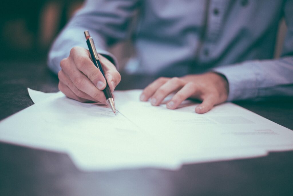 man signing documents