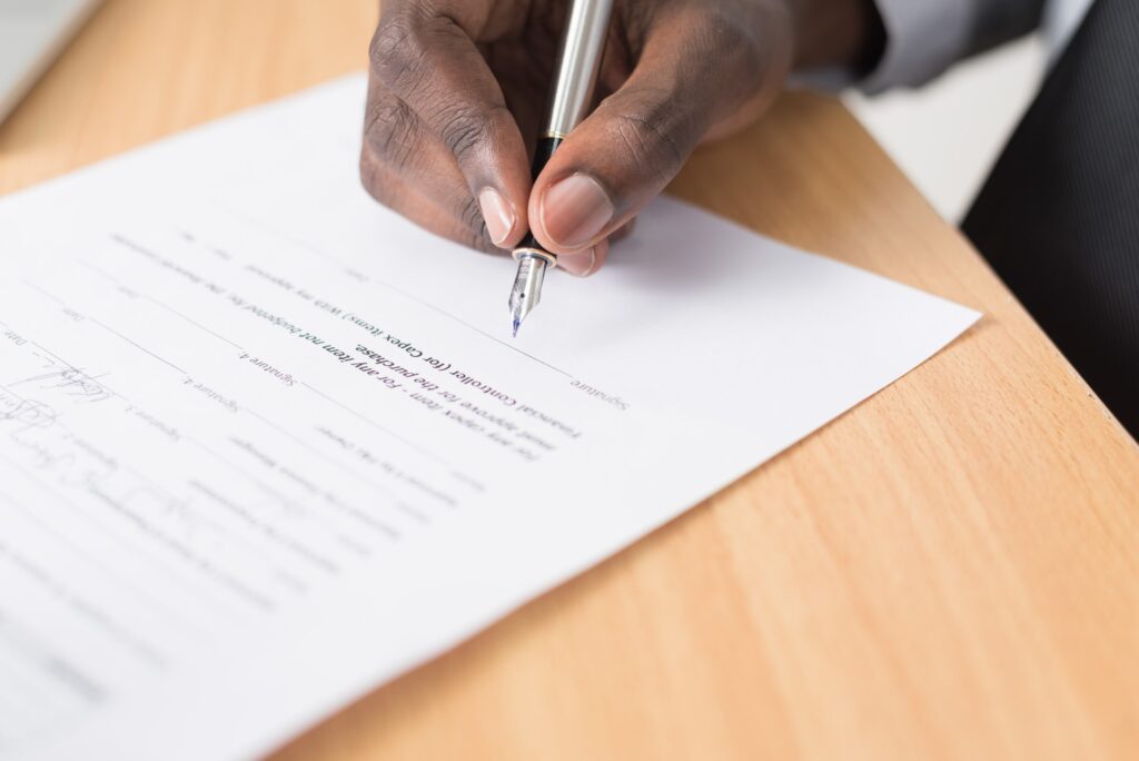black man signing a document