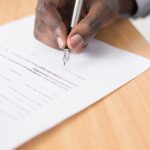 black man signing a document