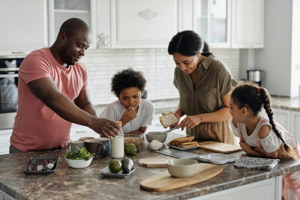 family making breakfast together in the kitchen