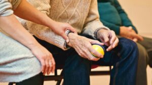 woman holding elderly person's hand