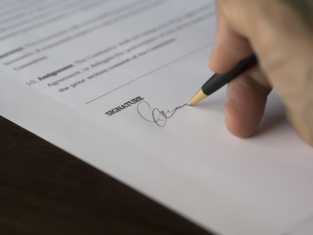 person signing a document