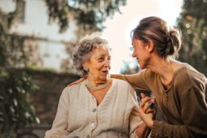 adult daughter with senior mother smiling