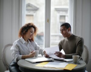 ethnic couple working together at the kitchen table