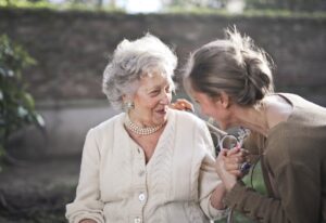 two adult women smiling at each other