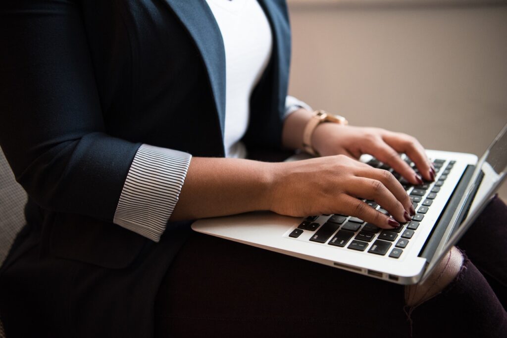 woman in suit working on laptop