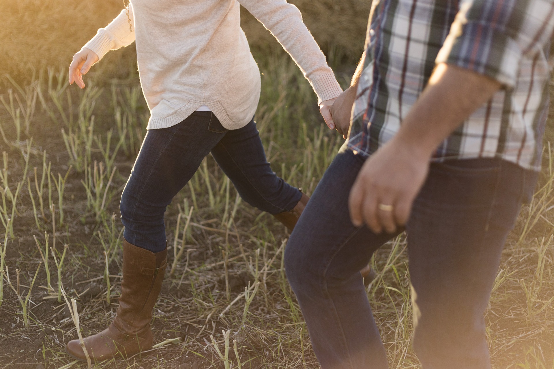 younger couple walking with hands together