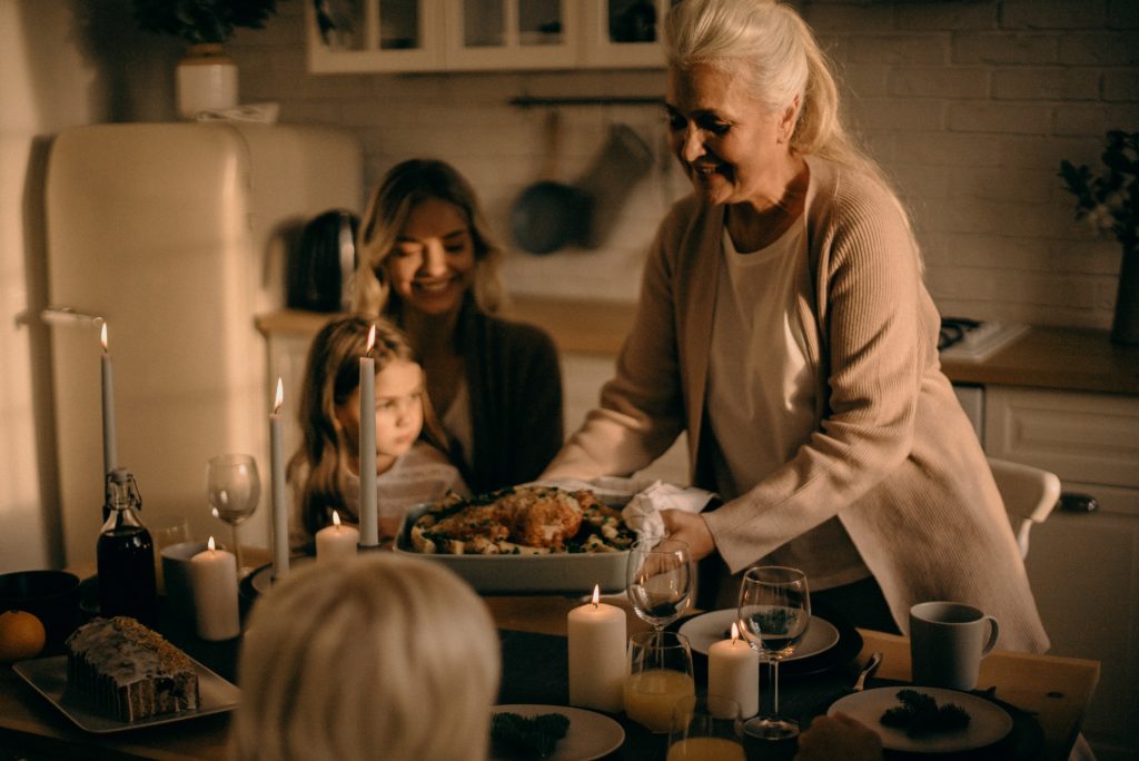 woman serving holiday meal to her family