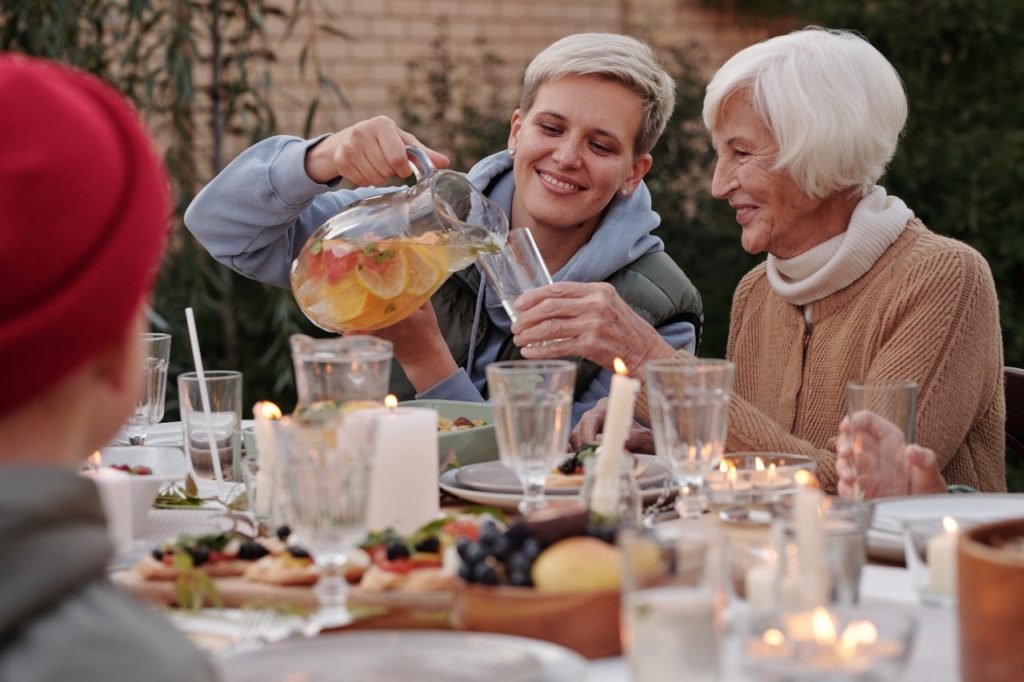 two women pouring lemonade at an outdoor family event