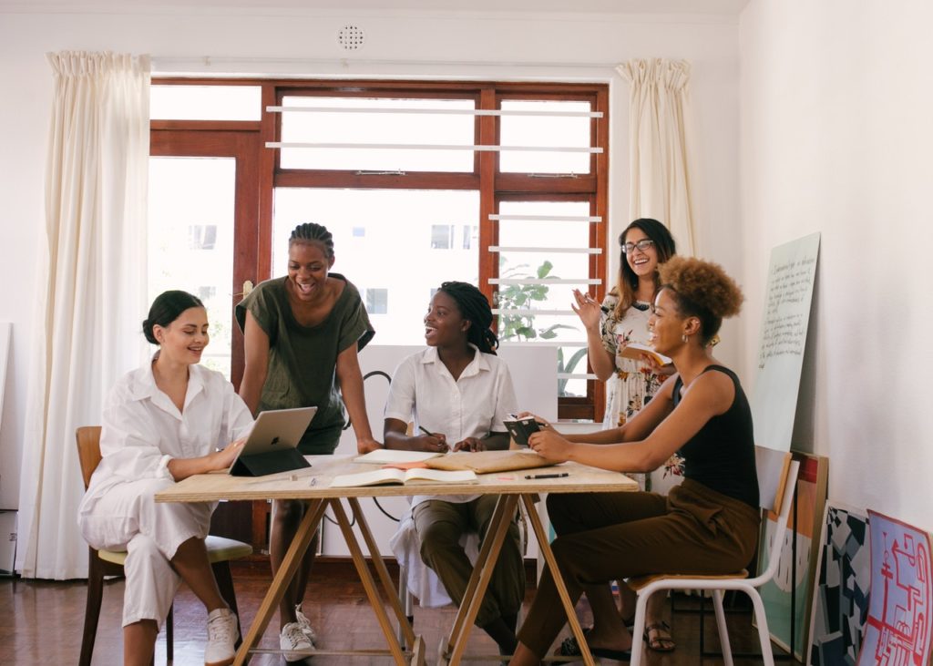 group of women having a meeting around a table