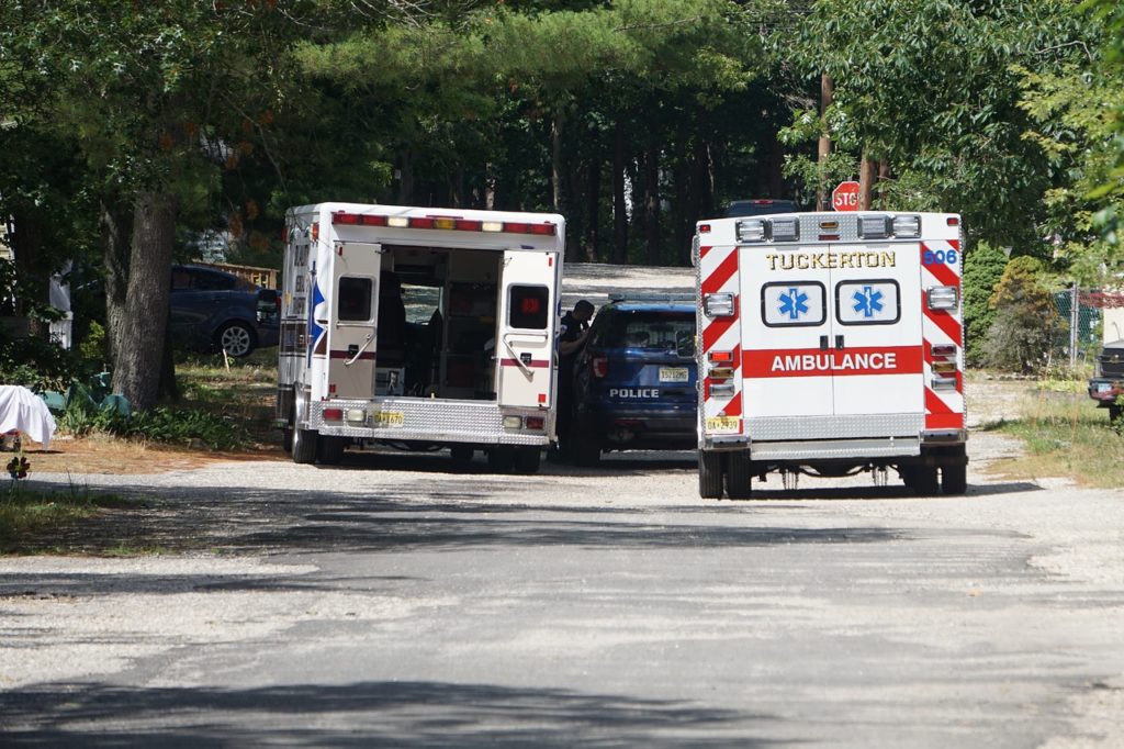 two ambulances and a police car at the scene of an accident