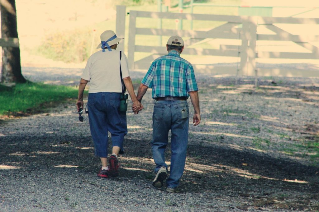 old couple walking while holding hands