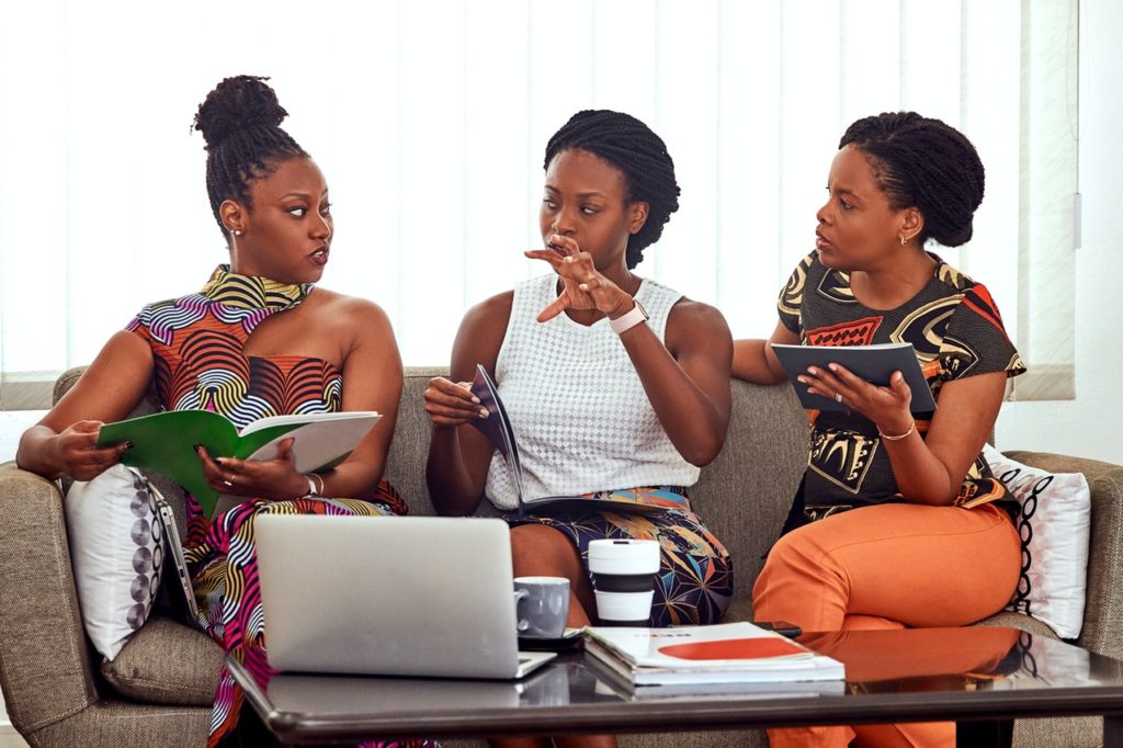 three black women talking to each other