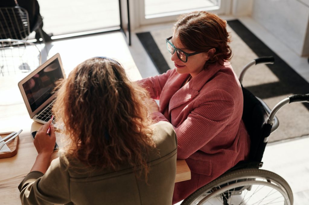 woman in wheelchair on computer