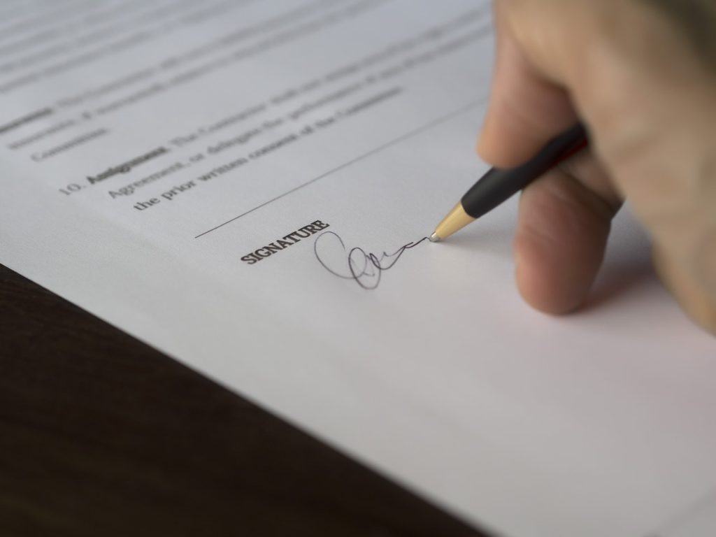 photo of signature agreement blur business close up