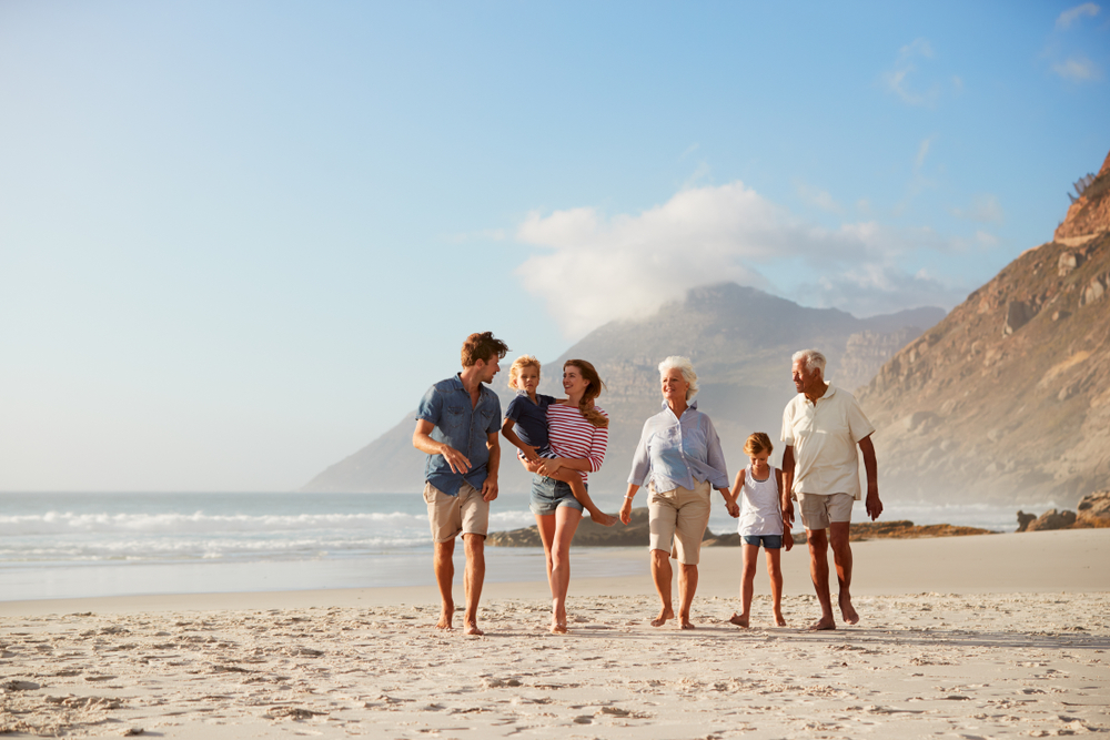 multi generational family walking on the beach