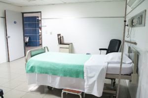 empty hospital bed in white room