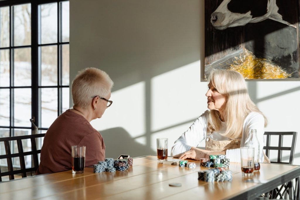 older women talking and sitting at table