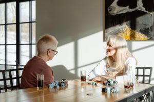 older women talking and sitting at table