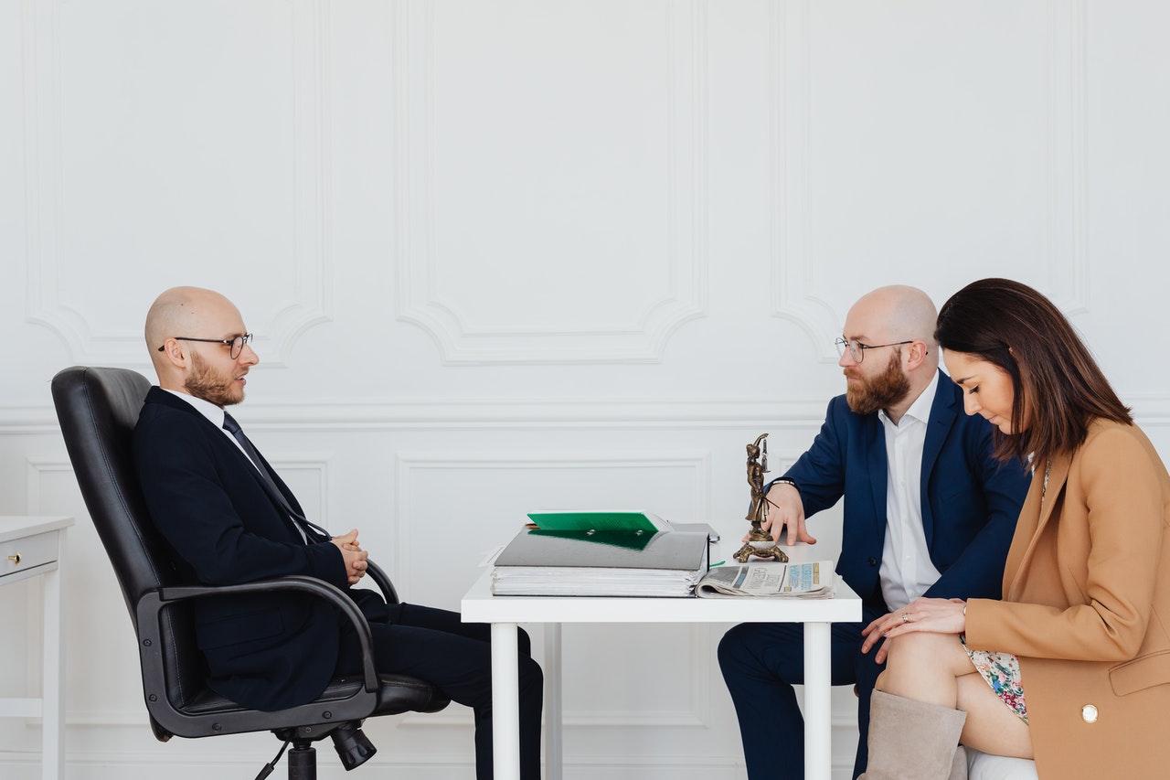 couple seated at desk across from an attorney