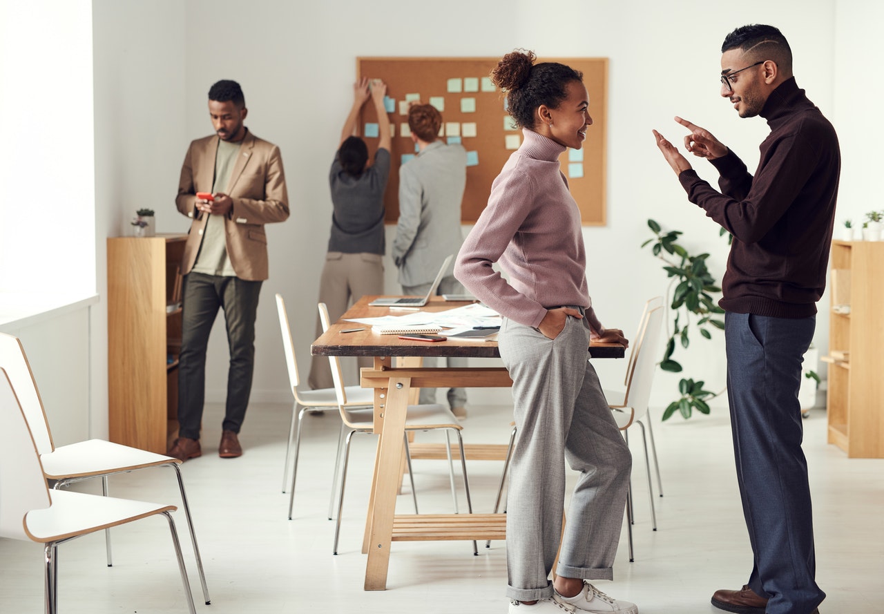 employees stand around an open office