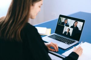 woman participates in zoom video call on laptop