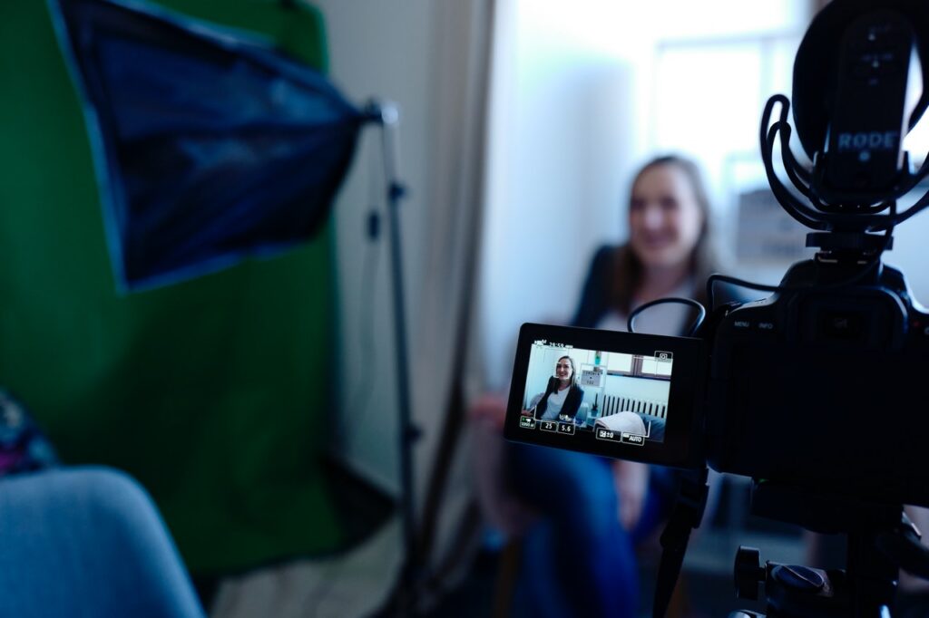 woman being filmed on video camera with lighting