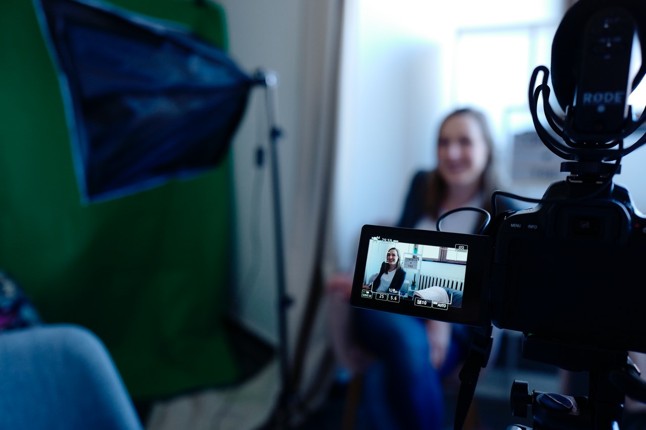 woman being filmed on video camera with lighting