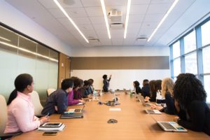 employees gathered around a conference room table for a meeting